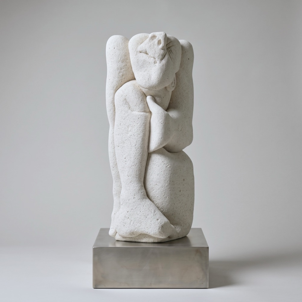 A vertical column of aerated concrete on a low steel base. A figure is folded into it, head bowed, an arm across the body, a knee drawn up the front.